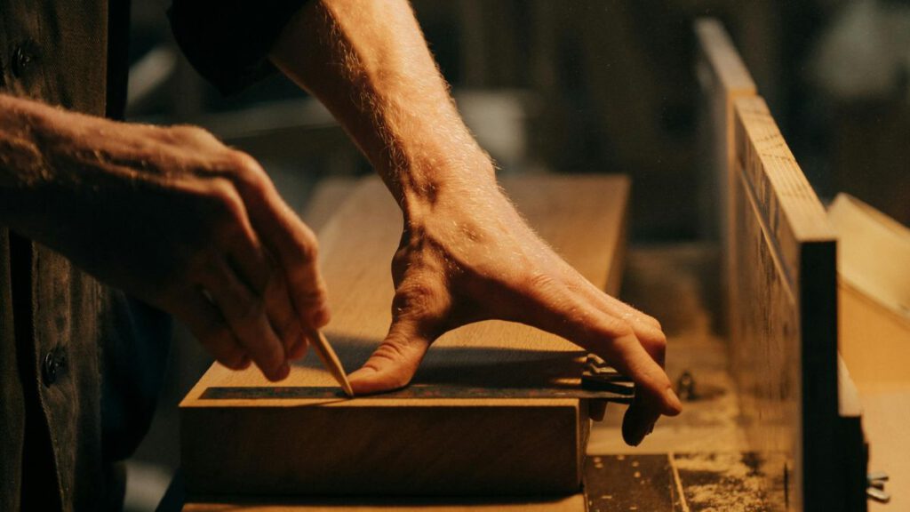 manos de ebanista trabajando la madera